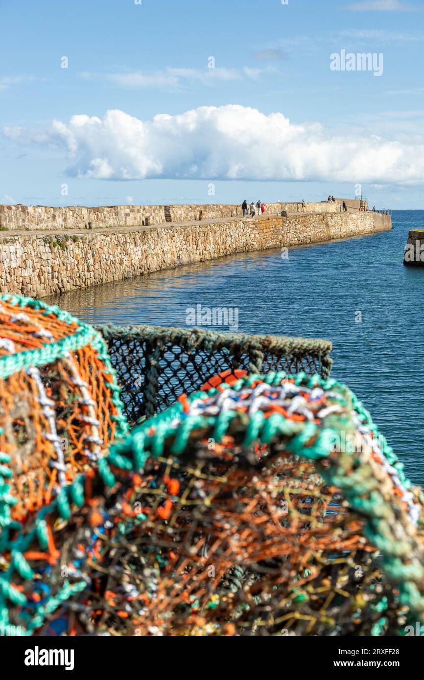 Lobster creels pilled up in front of St Andrews harbour, Fife, Scotland Stock Photo