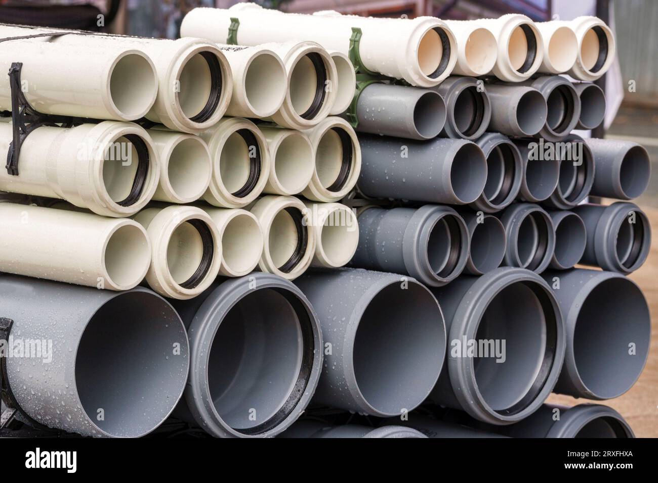 Plastic main black pipes. A heap of polyethylene pipes for a water