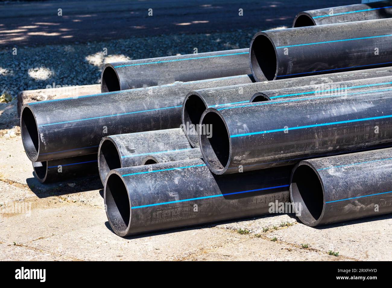 Plastic main black pipes. A heap of polyethylene pipes for a water