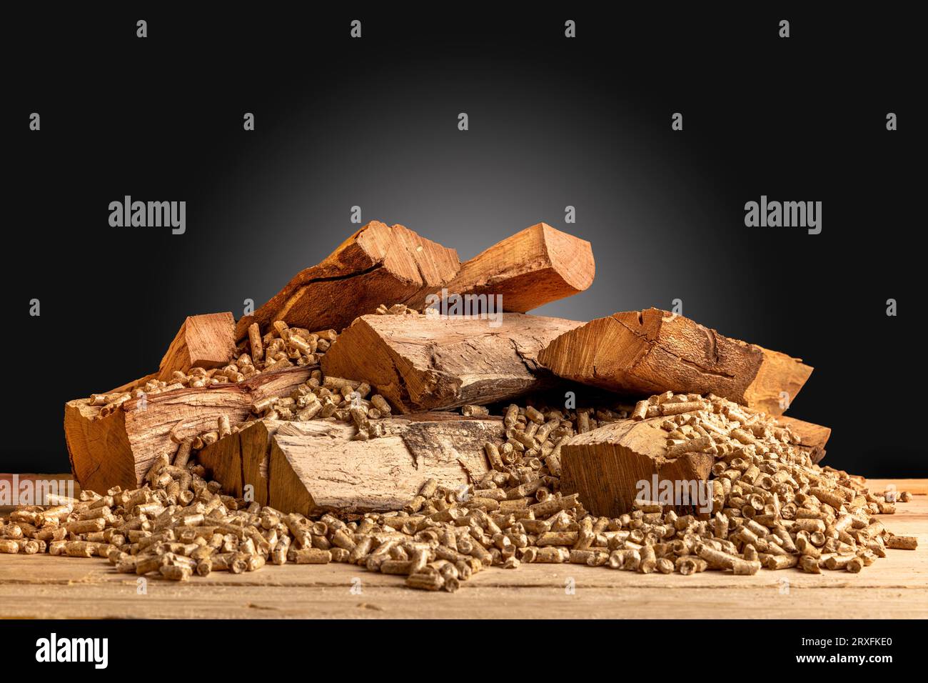 wood pellets and logs on a dark background Stock Photo