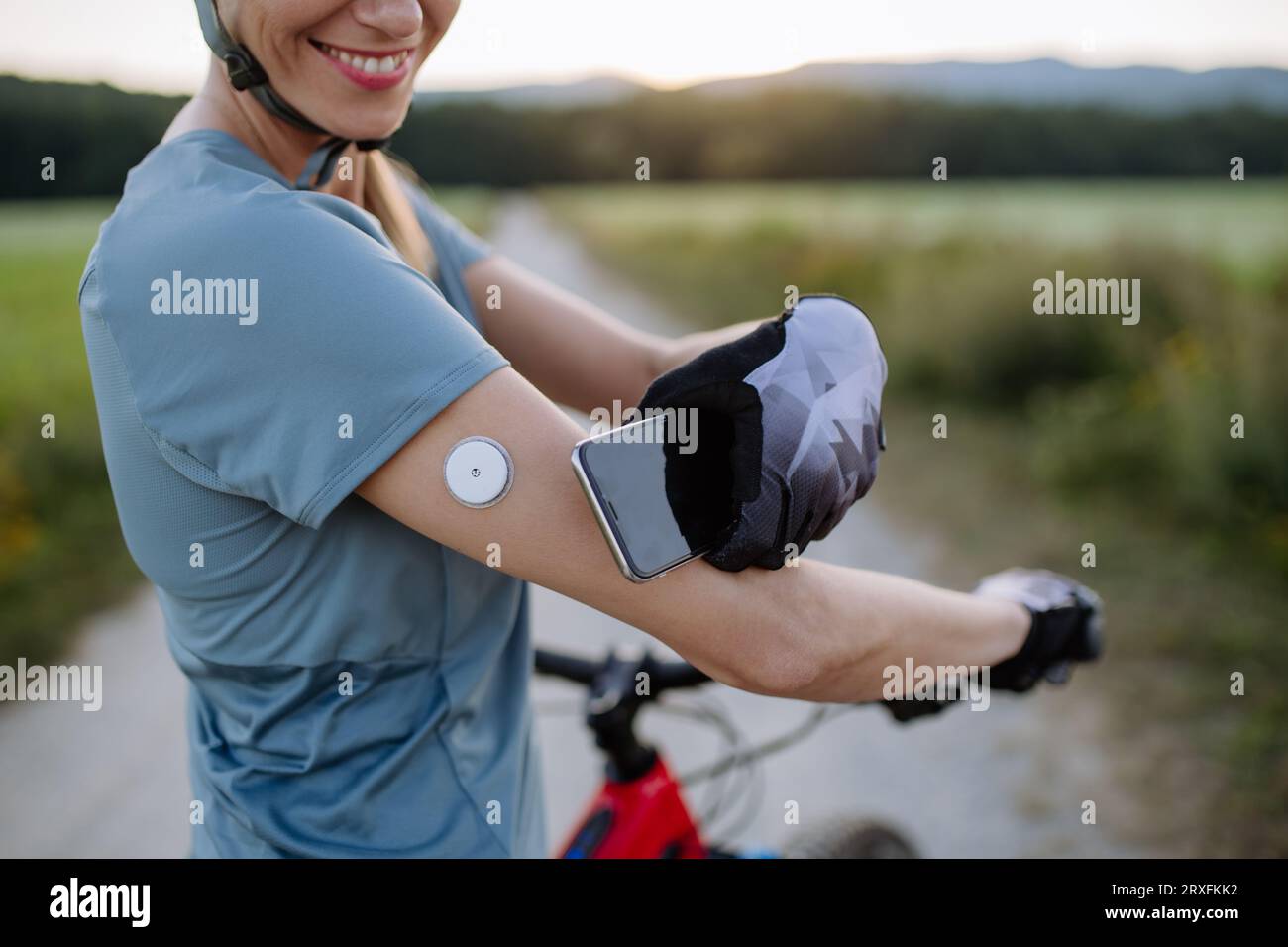 Diabetic cyclist connecting continuous glucose monitor with her