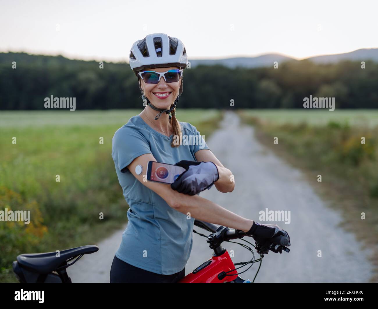 Diabetic cyclist connecting continuous glucose monitor with her