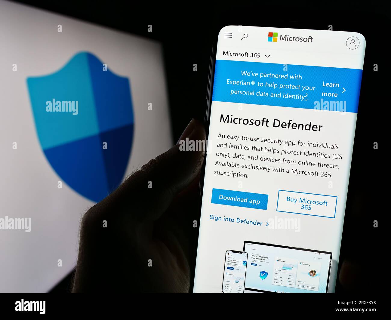 Person holding cellphone with webpage of security software Microsoft Defender Antivirus on screen with logo. Focus on center of phone display. Stock Photo