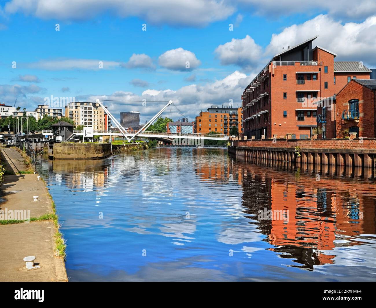 UK, West Yorkshire, Leeds Dock Apartments, River Aire and Knights Way Bridge from Towpath. Stock Photo
