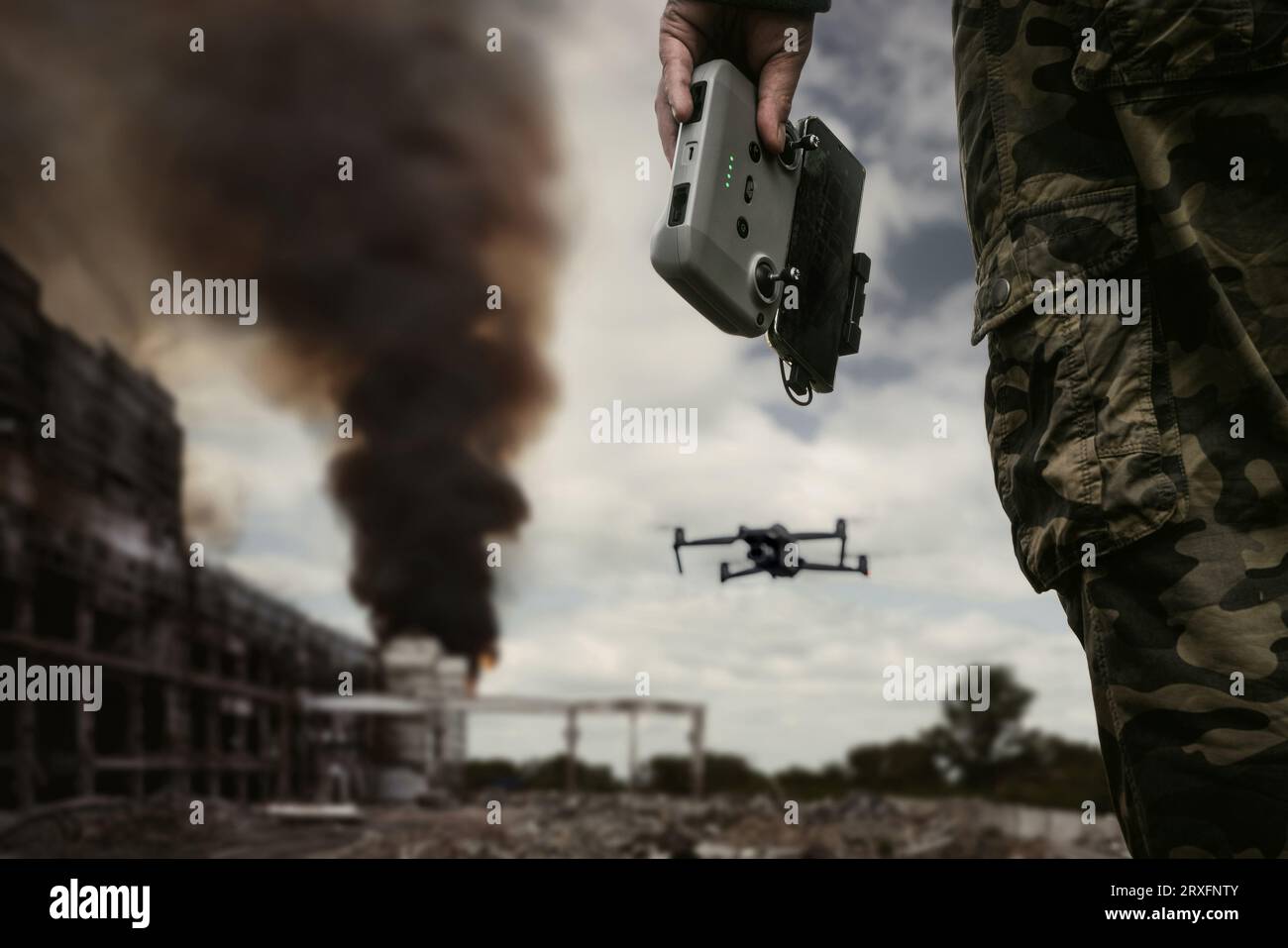 UAV operator with a remote control stands against the background of a ...