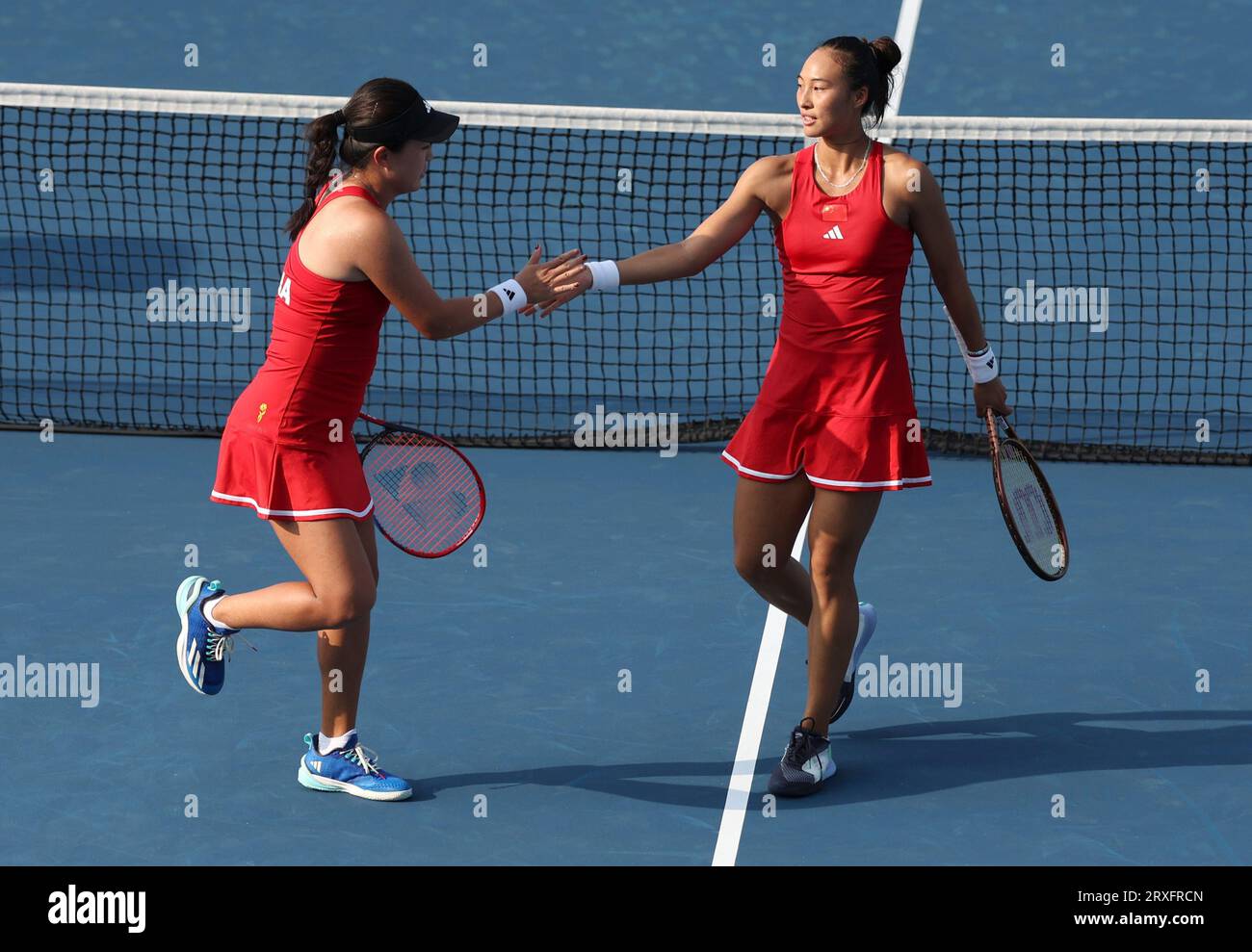 Hangzhou, China's Zhejiang Province. 25th Sep, 2023. Zhu Lin (L)/Zheng Qinwen of China react during the Women's Doubles Round Match of Tennis between Zhu Lin/Zheng Qinwen of China and Kobori Momoko/Shimizu Ayano of Japan at the 19th Asian Games in Hangzhou, east China's Zhejiang Province, Sept. 25, 2023. Credit: Meng Chenguang/Xinhua/Alamy Live News Stock Photo