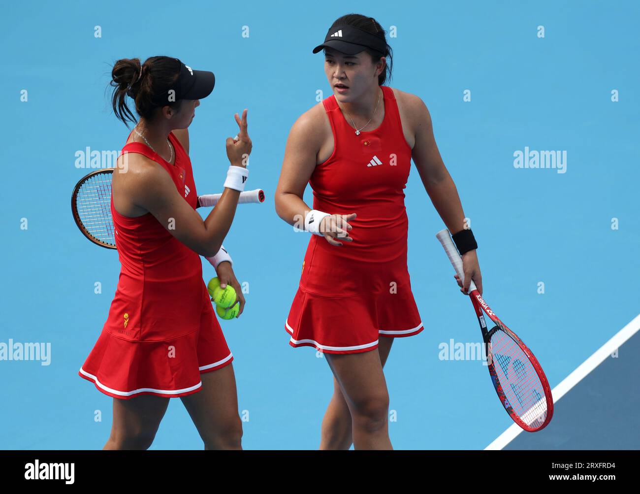 Hangzhou, China's Zhejiang Province. 25th Sep, 2023. Zhu Lin (R)/Zheng Qinwen of China react during the Women's Doubles Round Match of Tennis between Zhu Lin/Zheng Qinwen of China and Kobori Momoko/Shimizu Ayano of Japan at the 19th Asian Games in Hangzhou, east China's Zhejiang Province, Sept. 25, 2023. Credit: Meng Chenguang/Xinhua/Alamy Live News Stock Photo