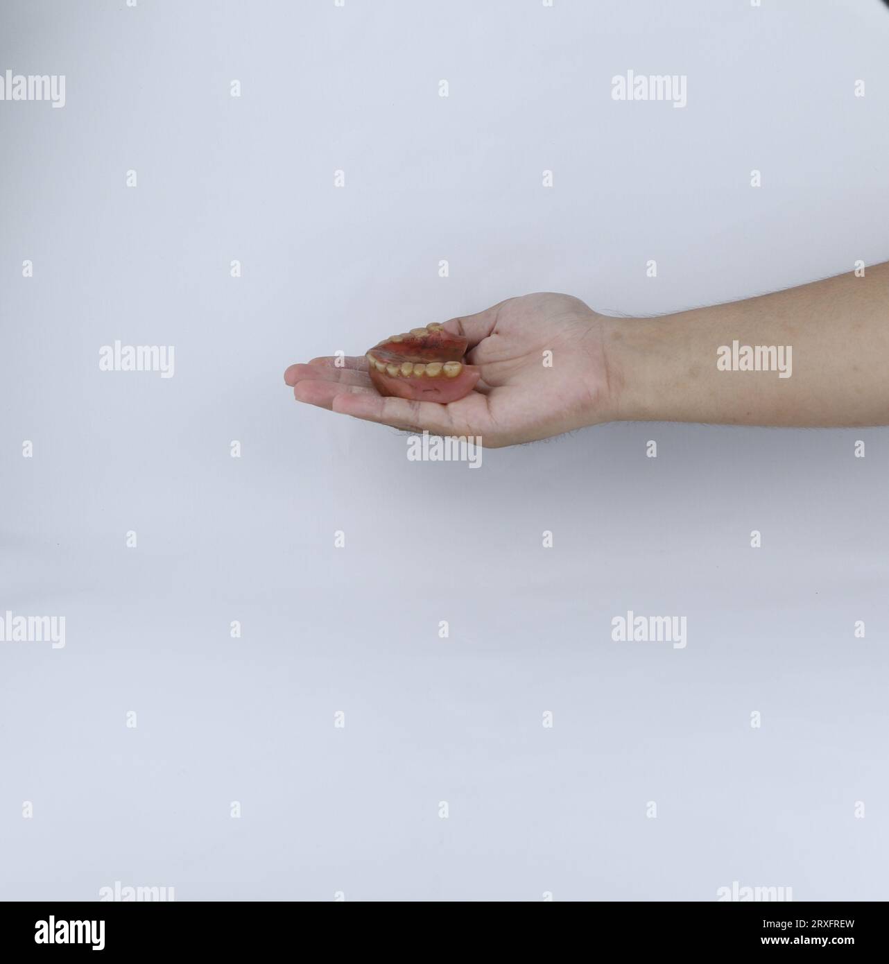 hands holding dirty dentures Stock Photo Alamy