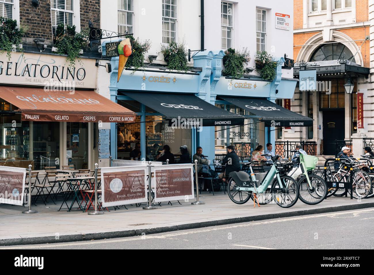 London, UK - August 25, 2023: Unknown people enjoy a breakfast sitting on the terrace of a cafe near Covent Garden. Stock Photo