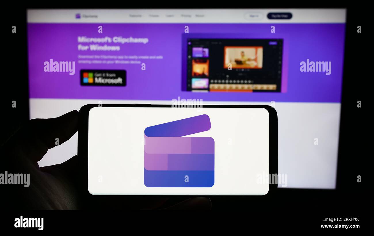 Person holding mobile phone with logo of video editing software