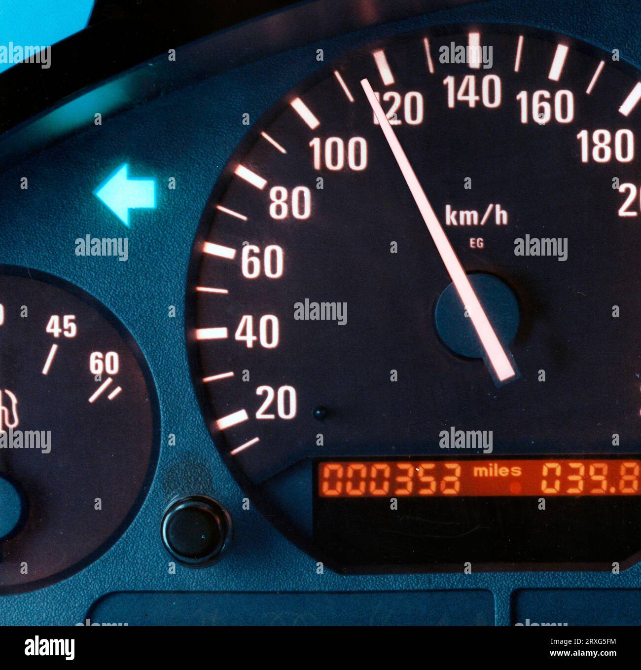 Speedometer needle points to over 100km h, detail from a speedometer
