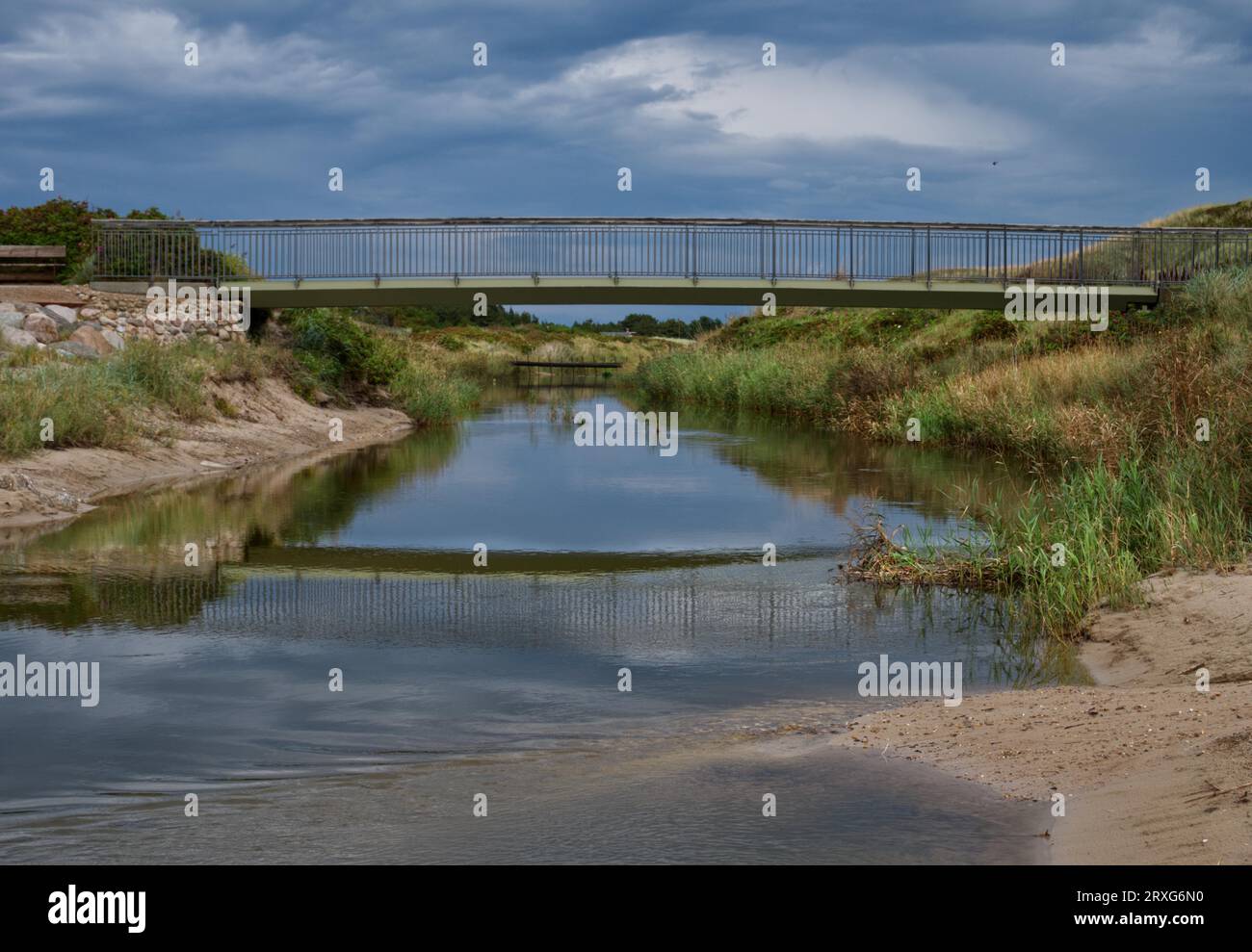 The mirrored bridge over Henne A Stock Photo