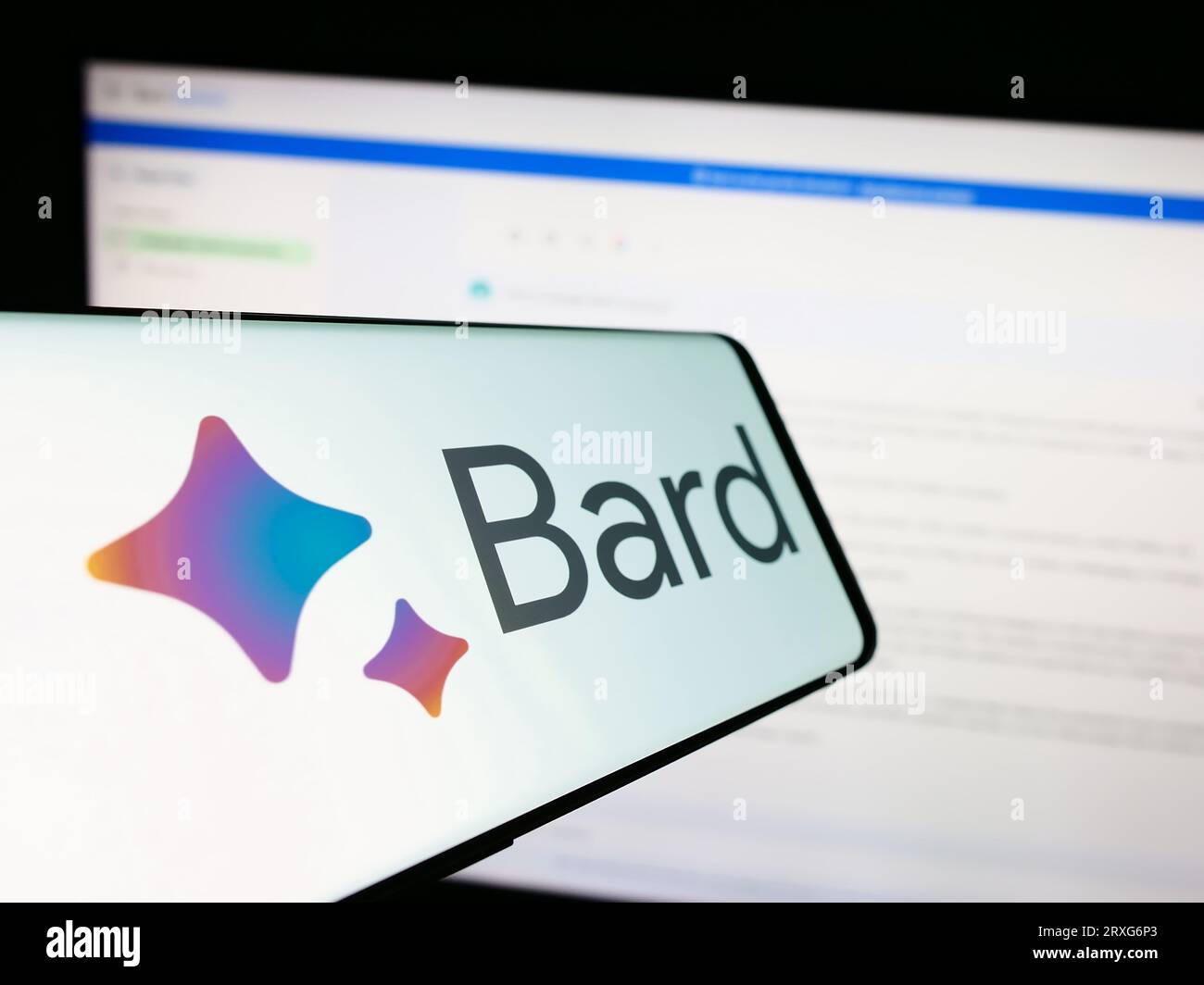 Smartphone with logo of generative AI chatbot Google Bard on screen in front of business website. Focus on center-left of phone display. Stock Photo