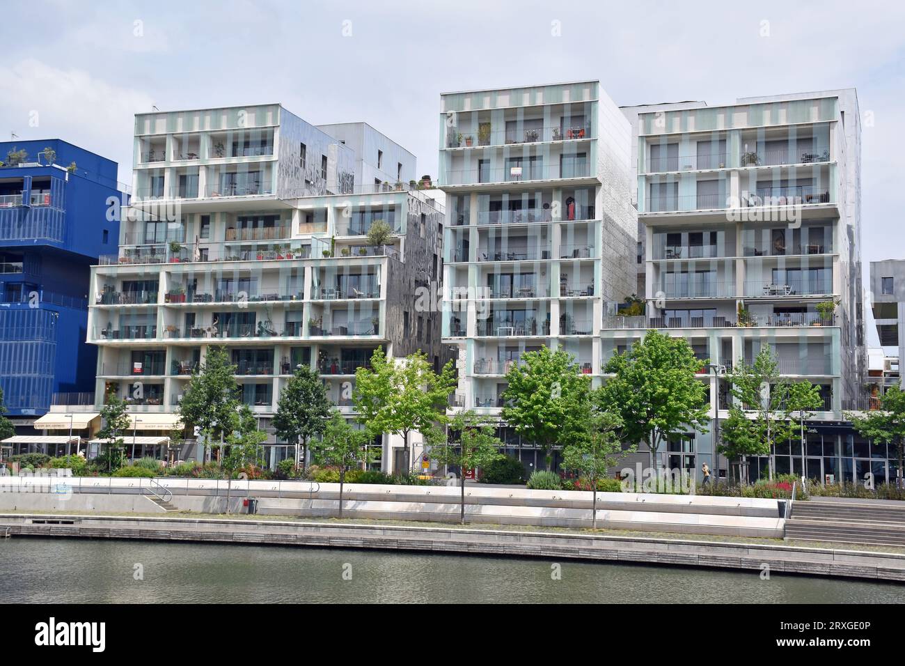 A string of assorted luxury apartment buildings in the La Confluence quarter, looking south over a boating marina off the R Sâone, in Lyon, France Stock Photo