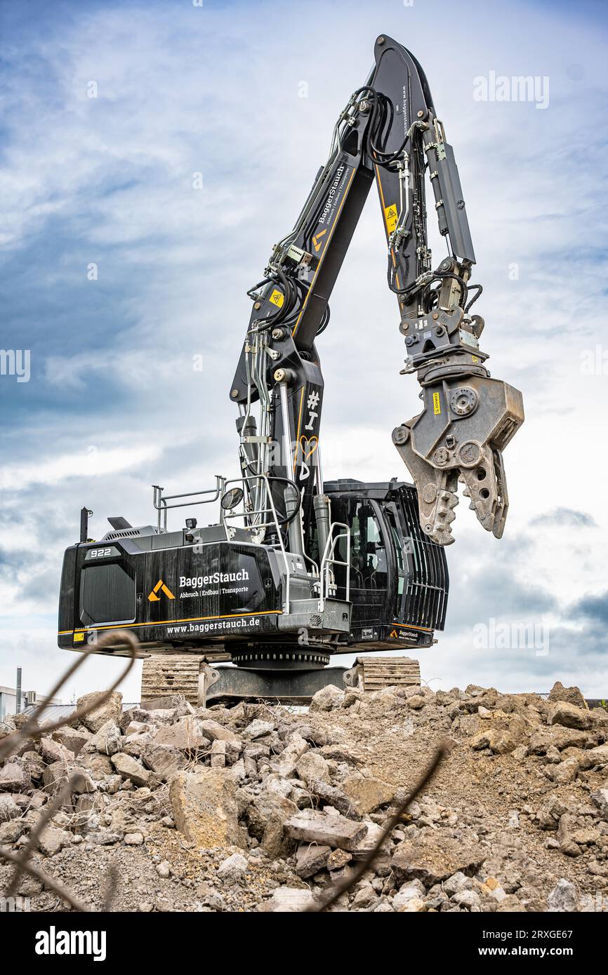 Black Liebherr crawler excavator recycling on demolition site