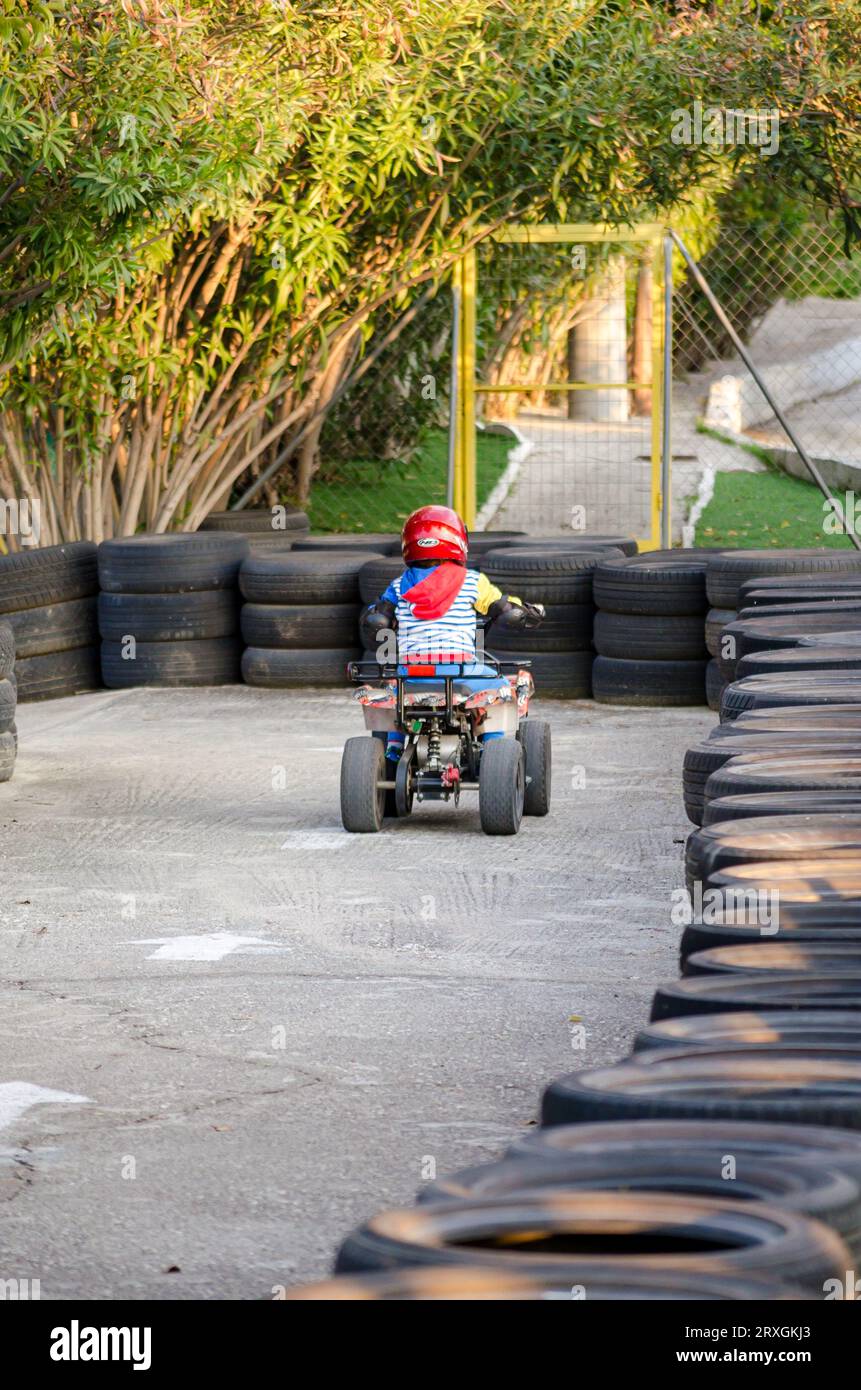 Little Boy Rides a Motorcycle ATV with Four Wheels. Outdoor Activity