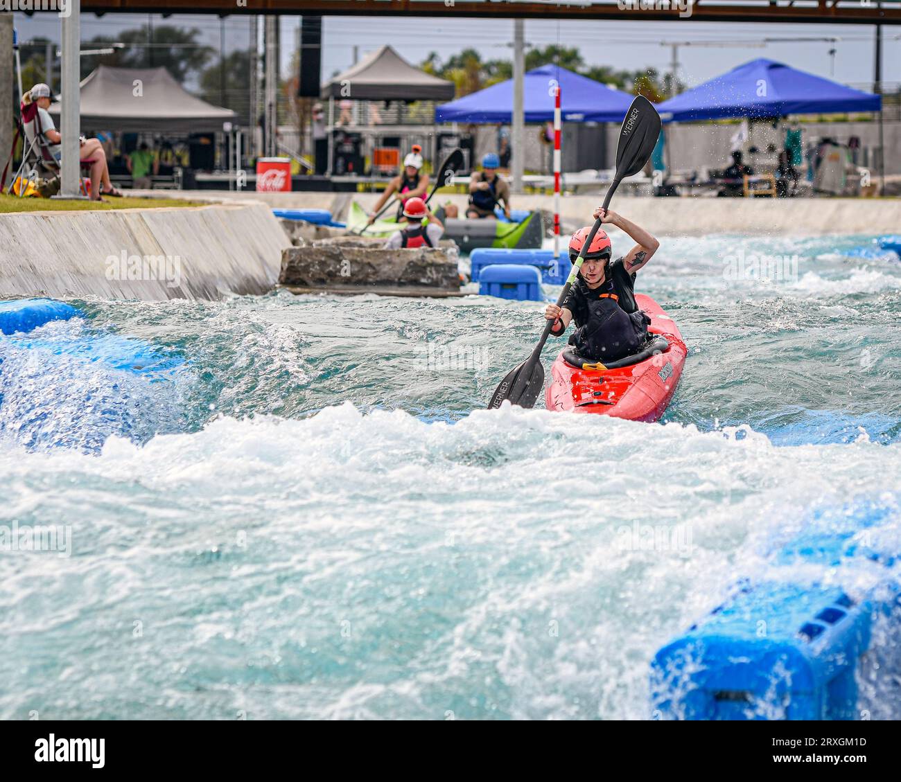 Montgomery, Alabama, USA-Sept. 2, 2023: Female caucasian kayaker traverses the course in a practice run at Montgomery Whitewater's Golden Hour Kayak C Stock Photo