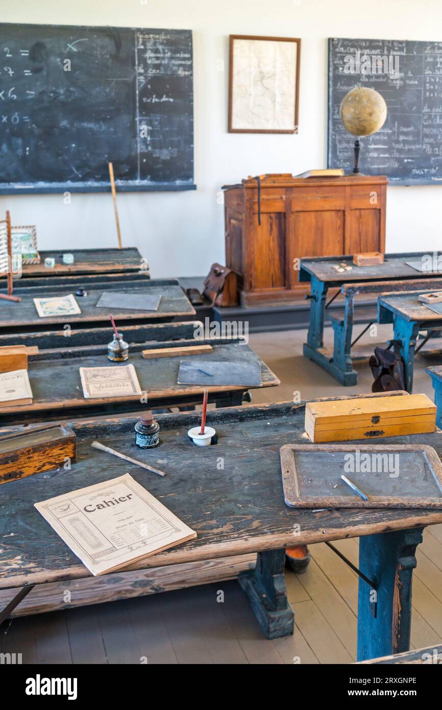 1920s classroom of country school showing old desk with slate, inkpot and notebook at museum of Walloon rural life, Saint-Hubert, Ardennes, Belgium Stock Photo
