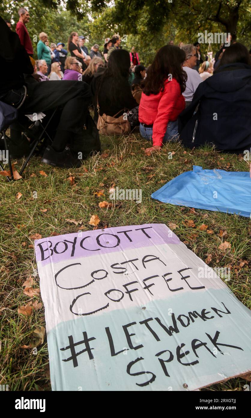 A 'Boycott Costa Coffee' sign lays on the grass outside the circle in
