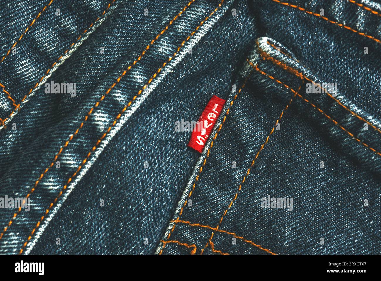 Closeup of Levis red tag on back side pocket. Classic blue Levis jeans. Levi Strauss is an american clothing company Stock Photo