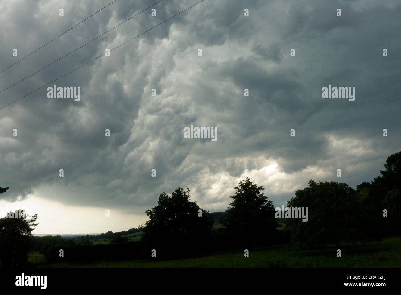 Dark storm clouds over Meon Hill near Mickleton Chipping Campden UK Stock Photo