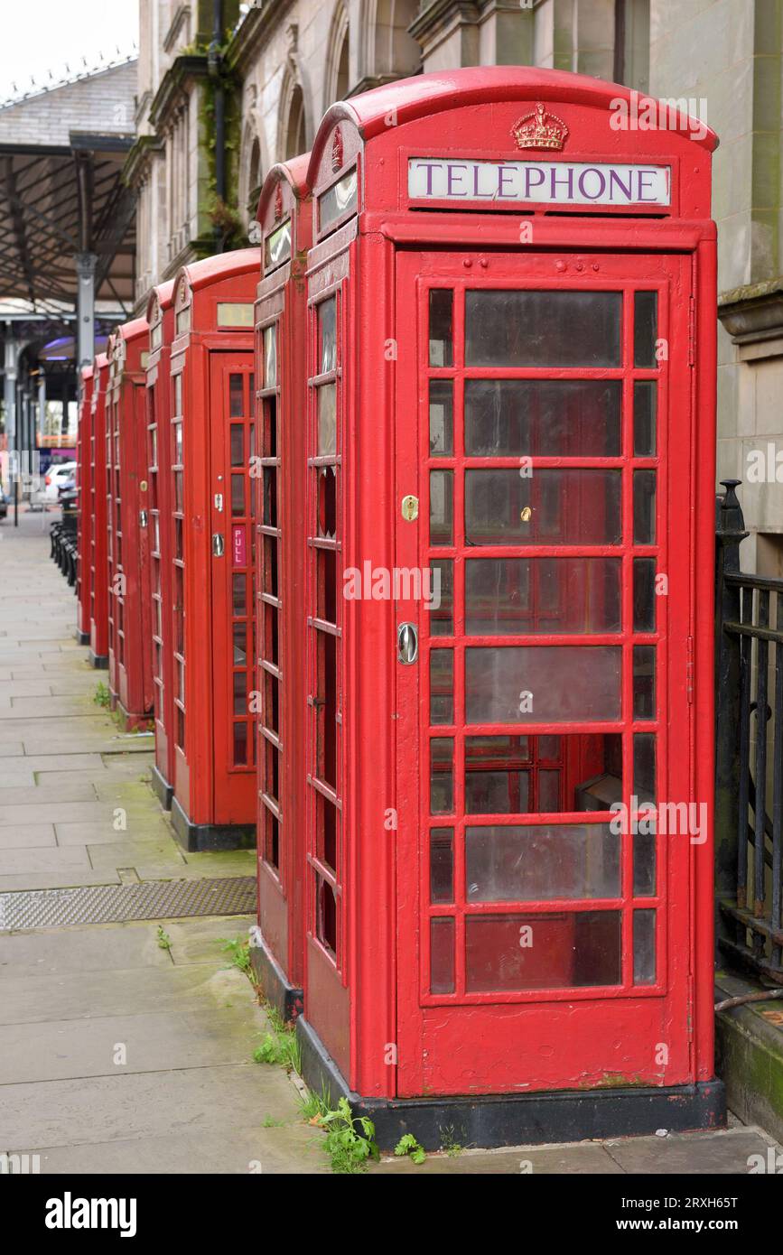 Old red telephone boxes on Market Street in the Cirt of Preston. Stock Photo