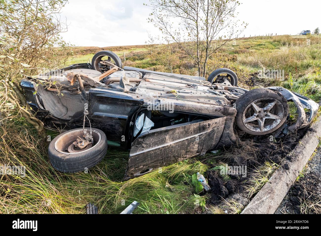 A6033 road, West Yorkshire. 25th September 2023. RTA, road traffic accident on the A6033 between Pecket Well and Oxenhope  with car upside down and the drivers door open. The car was a 2008 Black Diesel Vauxhall Astra based upon its rear number plate. The driver was not present. No police aware tape on or in the near the vincinity of the vehicle or police present. The inside of the car appeared to be intact, no obvious damage, signs of injury or blood. Cars were slowing and asking if anyone was trapped inside. Credit: Stephen Bell/Alamy Live News Stock Photo