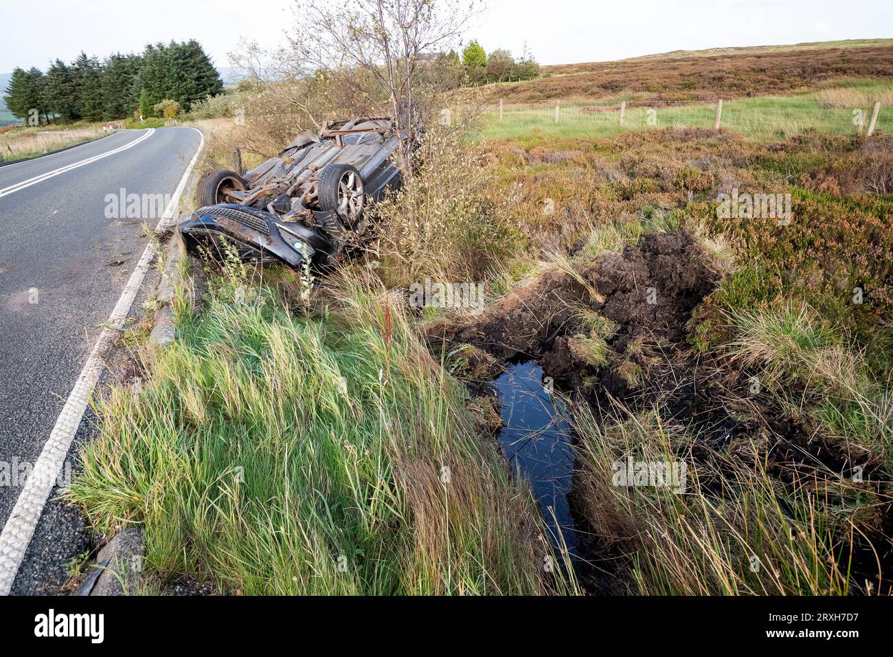 A6033 road, West Yorkshire. 25th September 2023. RTA, road traffic accident on the A6033 between Pecket Well and Oxenhope  with car upside down and the drivers door open. The car was a 2008 Black Diesel Vauxhall Astra based upon its rear number plate. The driver was not present. No police aware tape on or in the near the vincinity of the vehicle or police present. The inside of the car appeared to be intact, no obvious damage, signs of injury or blood. Cars were slowing and asking if anyone was trapped inside. Credit: Stephen Bell/Alamy Live News Stock Photo