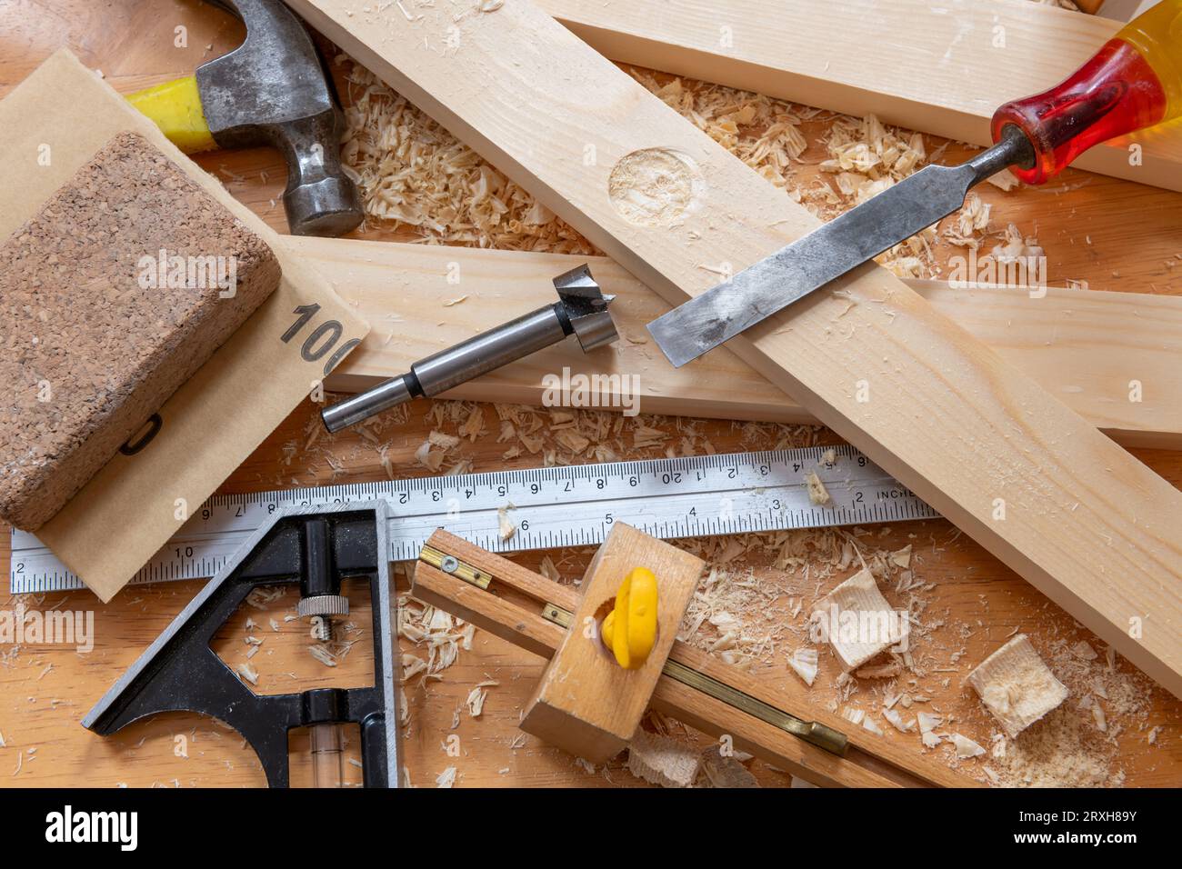 Timber, wood shavings and carpentry tools on a work bench Stock Photo