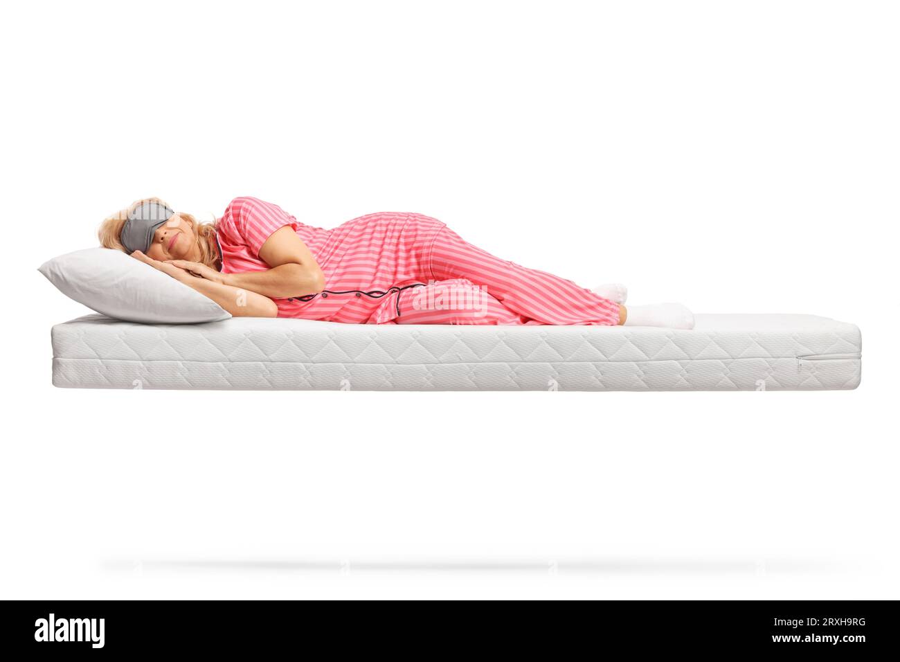 Woman in pajamas sleeping with a mask on a floating mattress isolated on white background Stock Photo