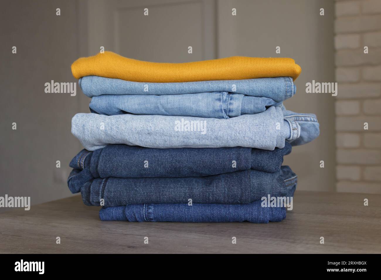 A neat stack of clean clothes prepared for the closet, the concept of neatness, order and having storage space, closets in the house. Stock Photo