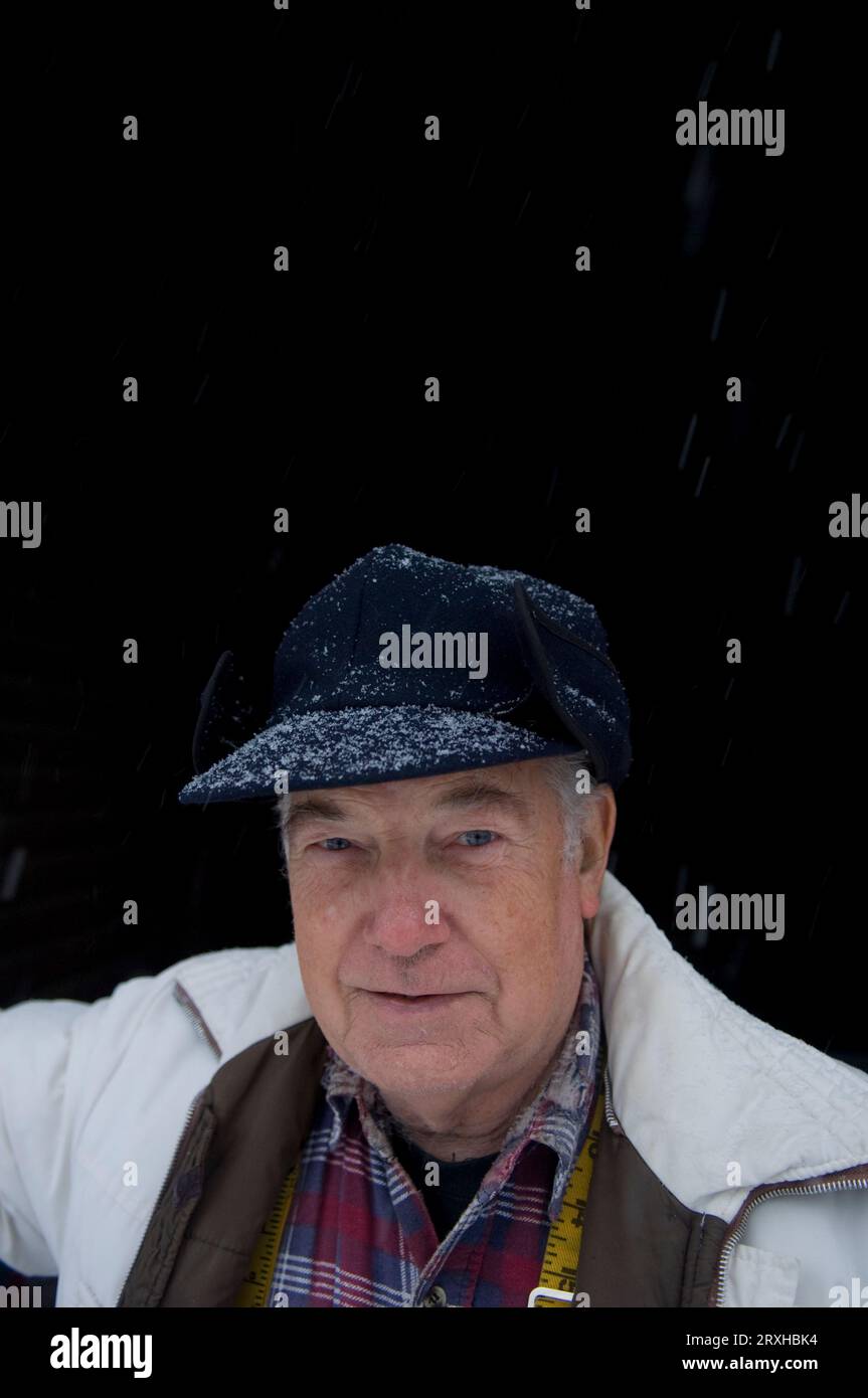 Close-up portrait of a senior man standing in a snowfall; Walton, Nebraska, United States of America Stock Photo