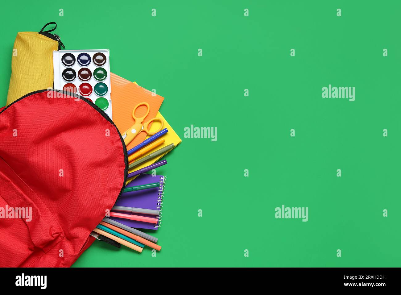 Stylish school backpack and different stationery on green background Stock Photo