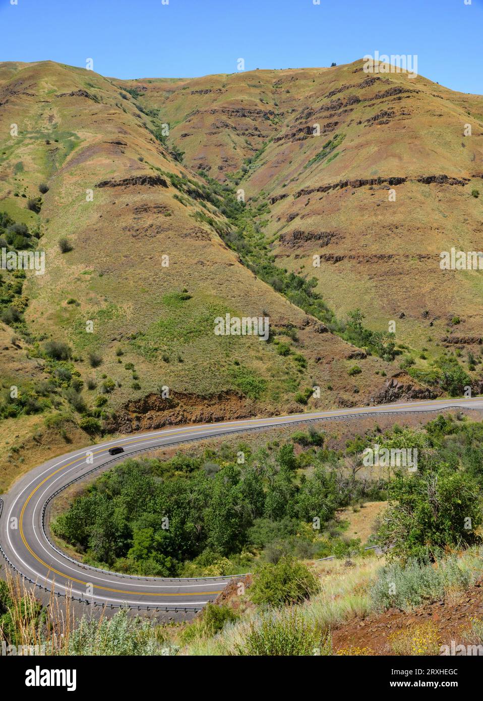 A car making the turn on a curvy section of Highway 129 in Eastern Washington near the Oregon border; Clarkston, Washington, United States of America Stock Photo