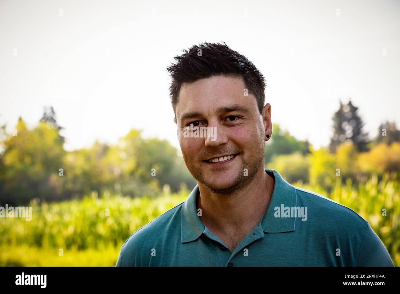 Outdoor portrait of a handsome mid-adult man in a city park in autumn