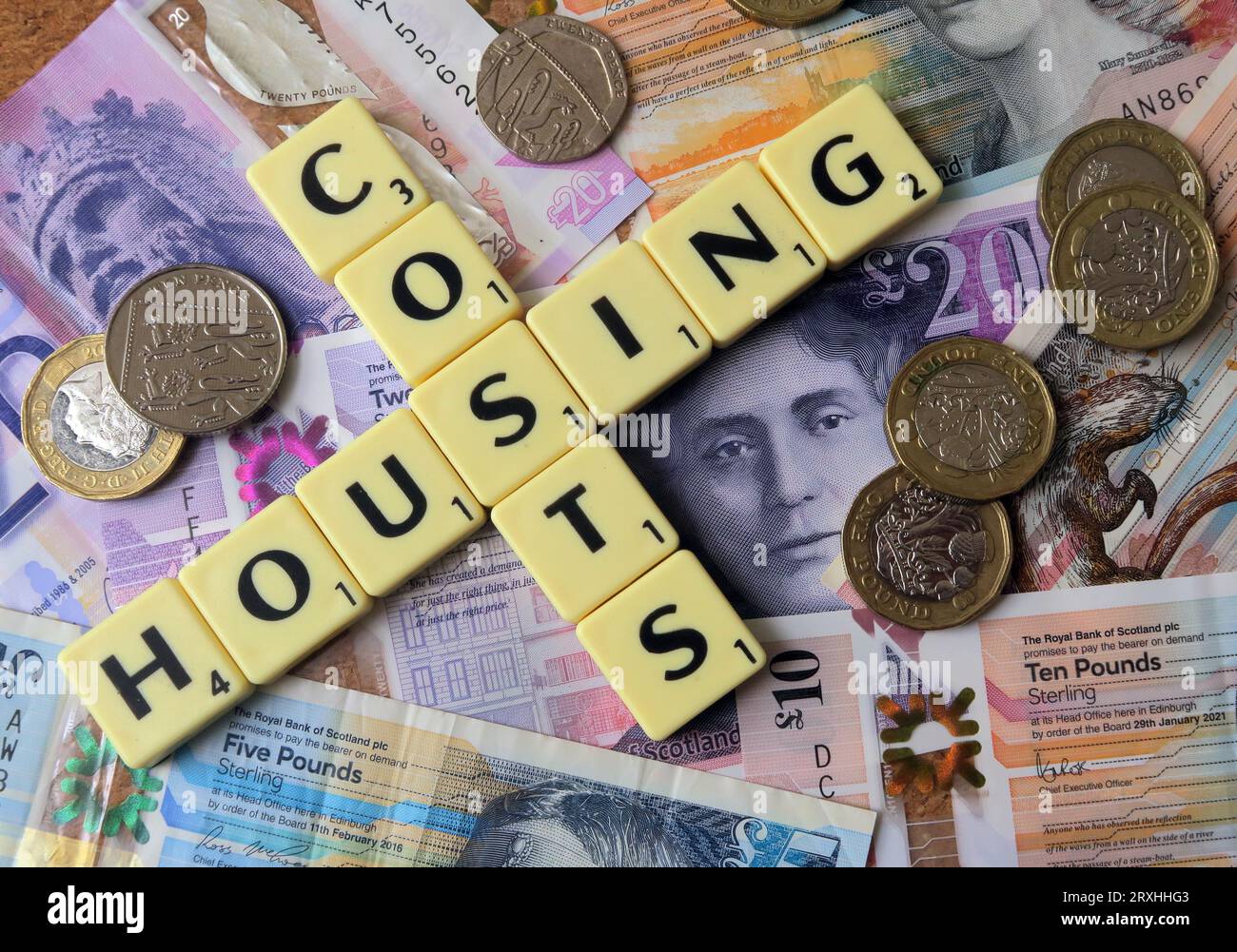 Housing costs - in words, Scrabble letters with Scottish Sterling cash notes, Scotland - Twenty Pounds, Ten Pounds, Five pound Stock Photo