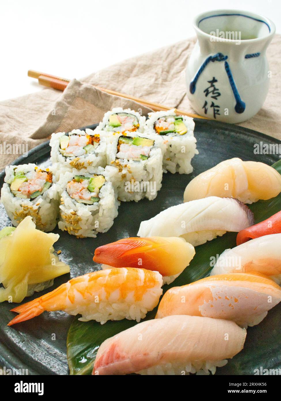Nigiri sushi with california roll and green tea. Stock Photo