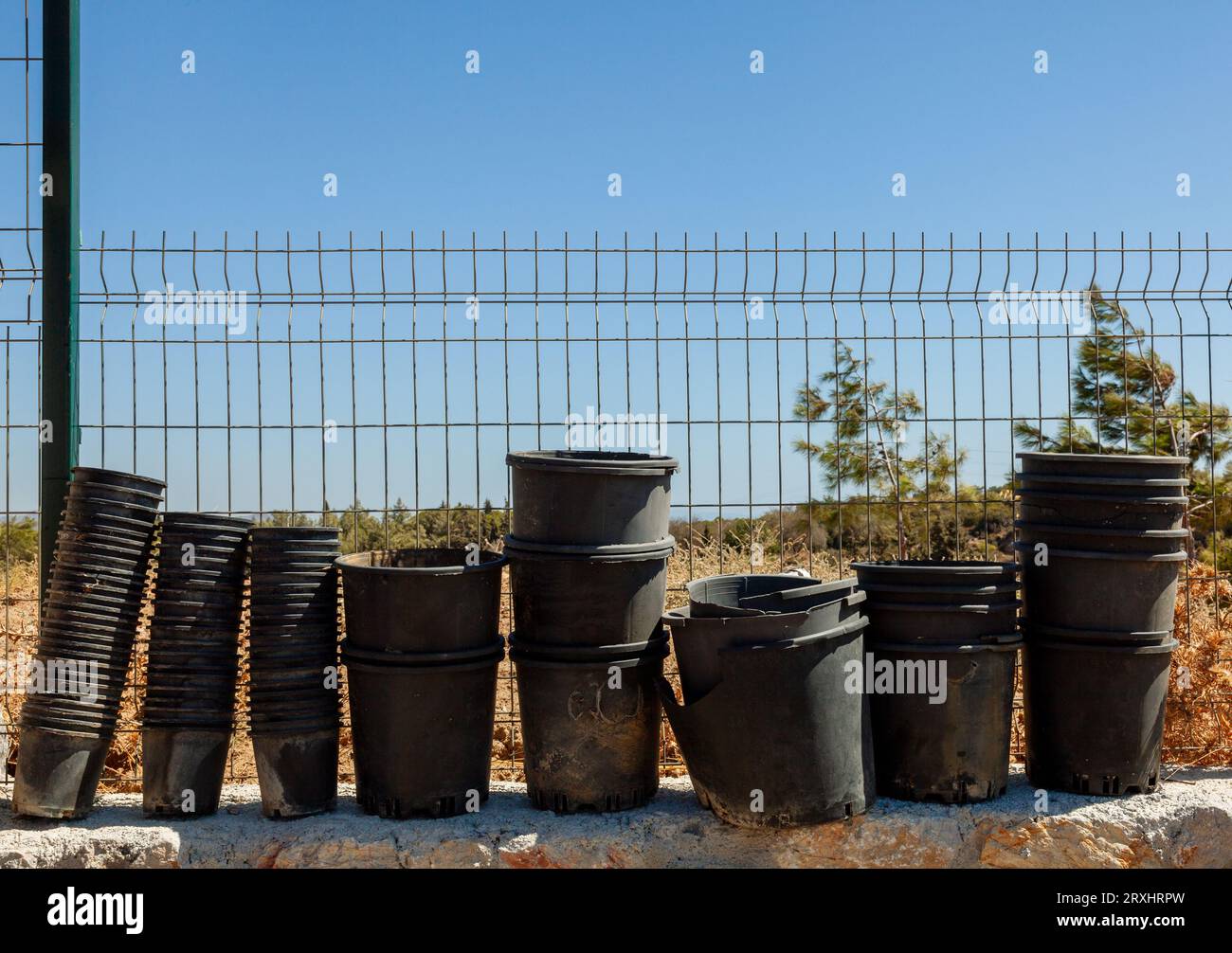 Used empty and wornout flower pots. Background of black plastic flower