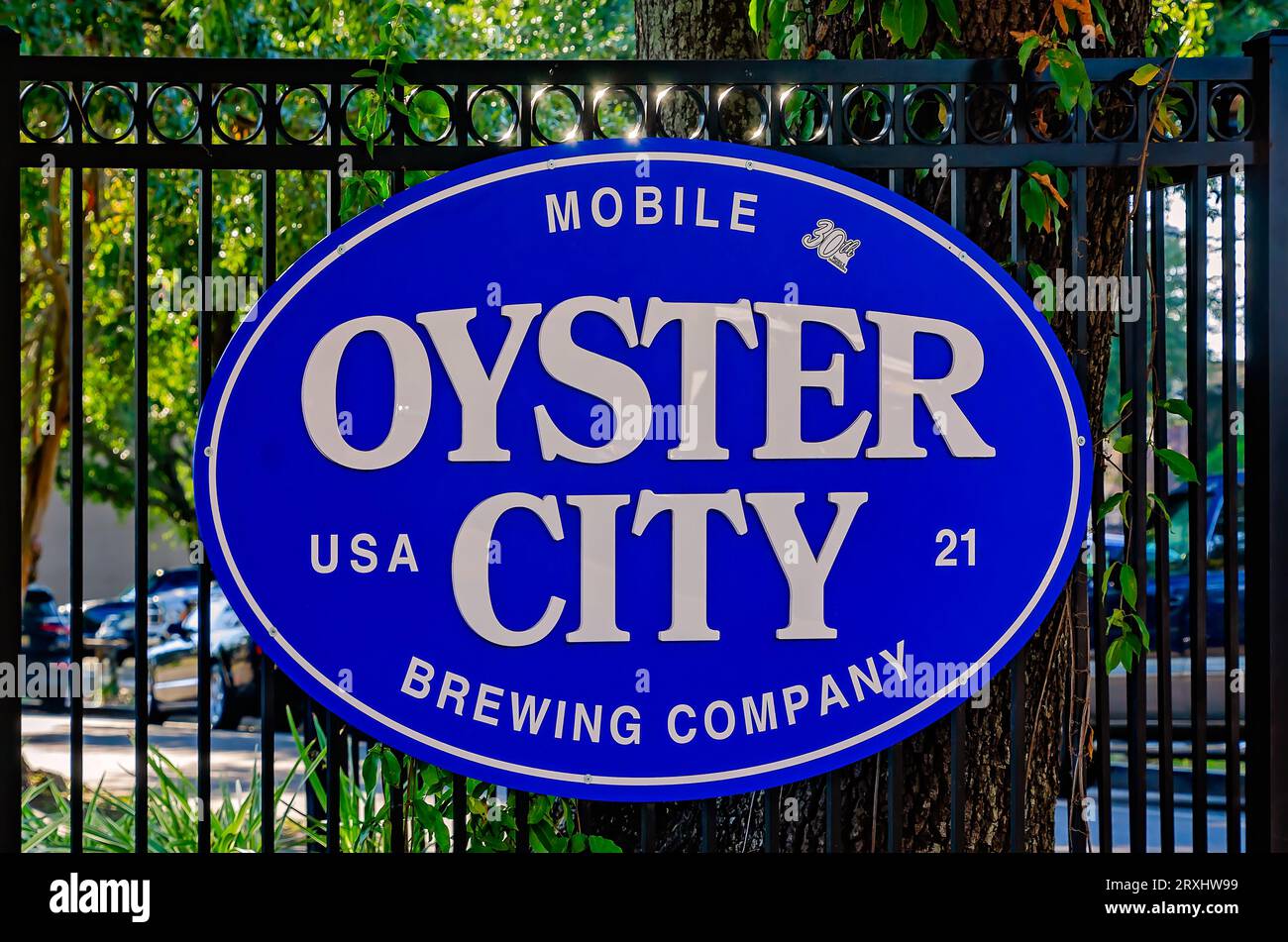 An Oyster City Brewing Company sign is pictured on a fence downtown