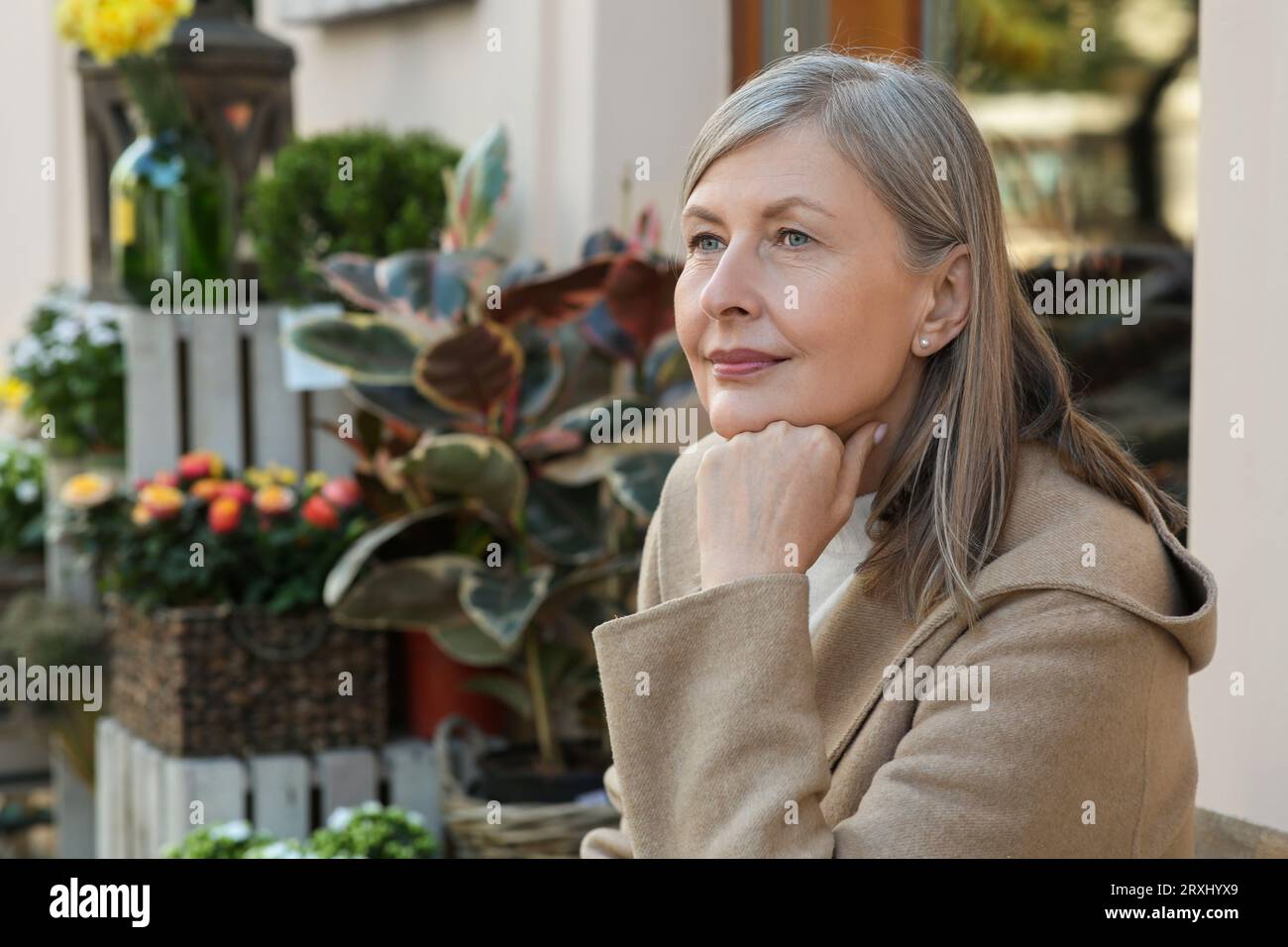Senior woman sitting outdoors hi-res stock photography and images - Alamy