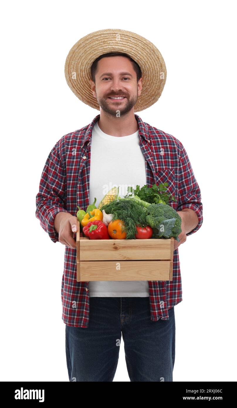 Harvesting season. Happy farmer holding wooden crate with vegetables on ...