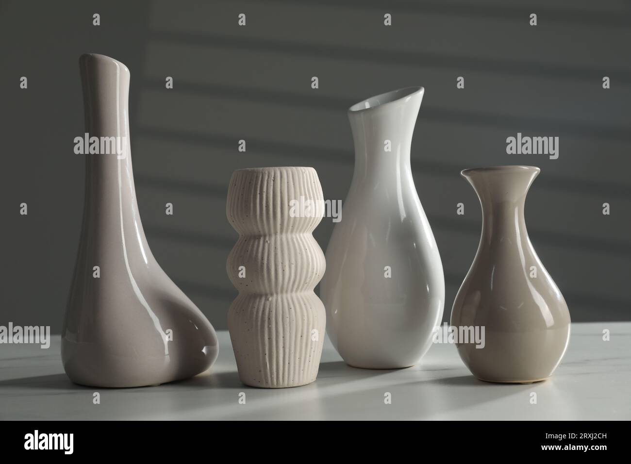 Different stylish vases on white marble table Stock Photo