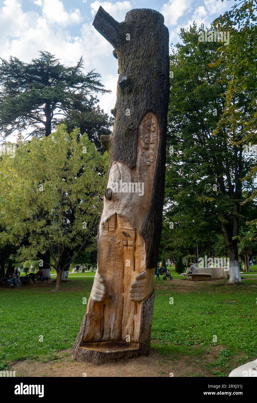 Carved picture on a tree in the park. Decorating a dead tree. Decoration of a public place. Landscaping. Dead tree in the park. Stock Photo