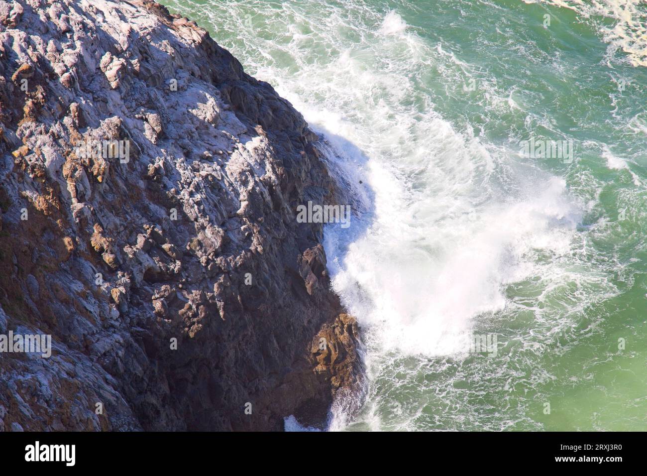 The Pacific Ocean beating up against the rocky coast in Oregon. Stock Photo