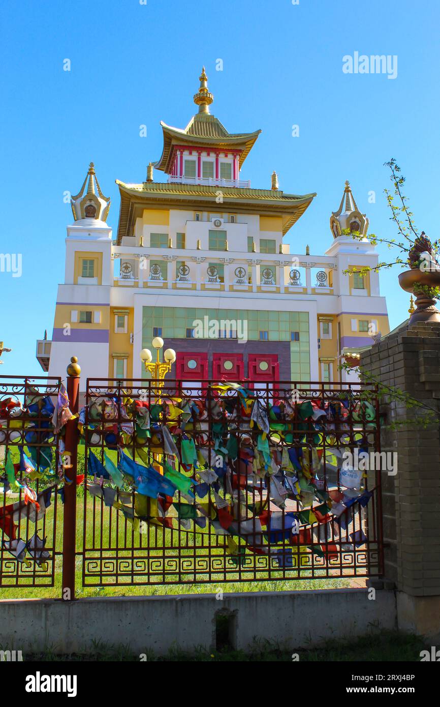 View of the Buddhist temple Golden Abode of Buddha Shakyamuni behind the gate. Elista, Republic of Kalmykia, Russia, blue sky with copy space Stock Photo