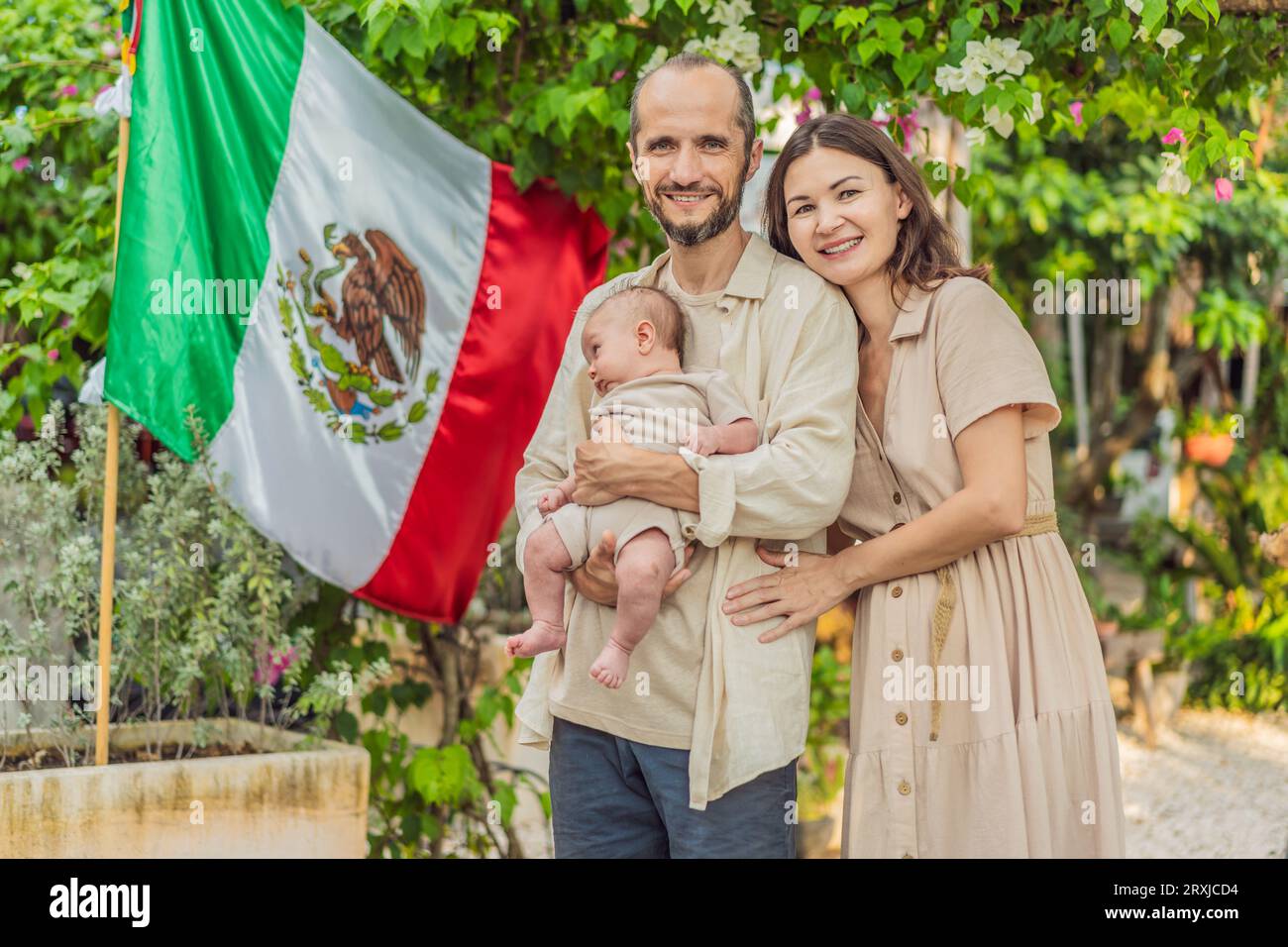 Immigrant family in front of the Mexican flag. New Mexicans. Childbirth in Mexico Stock Photo