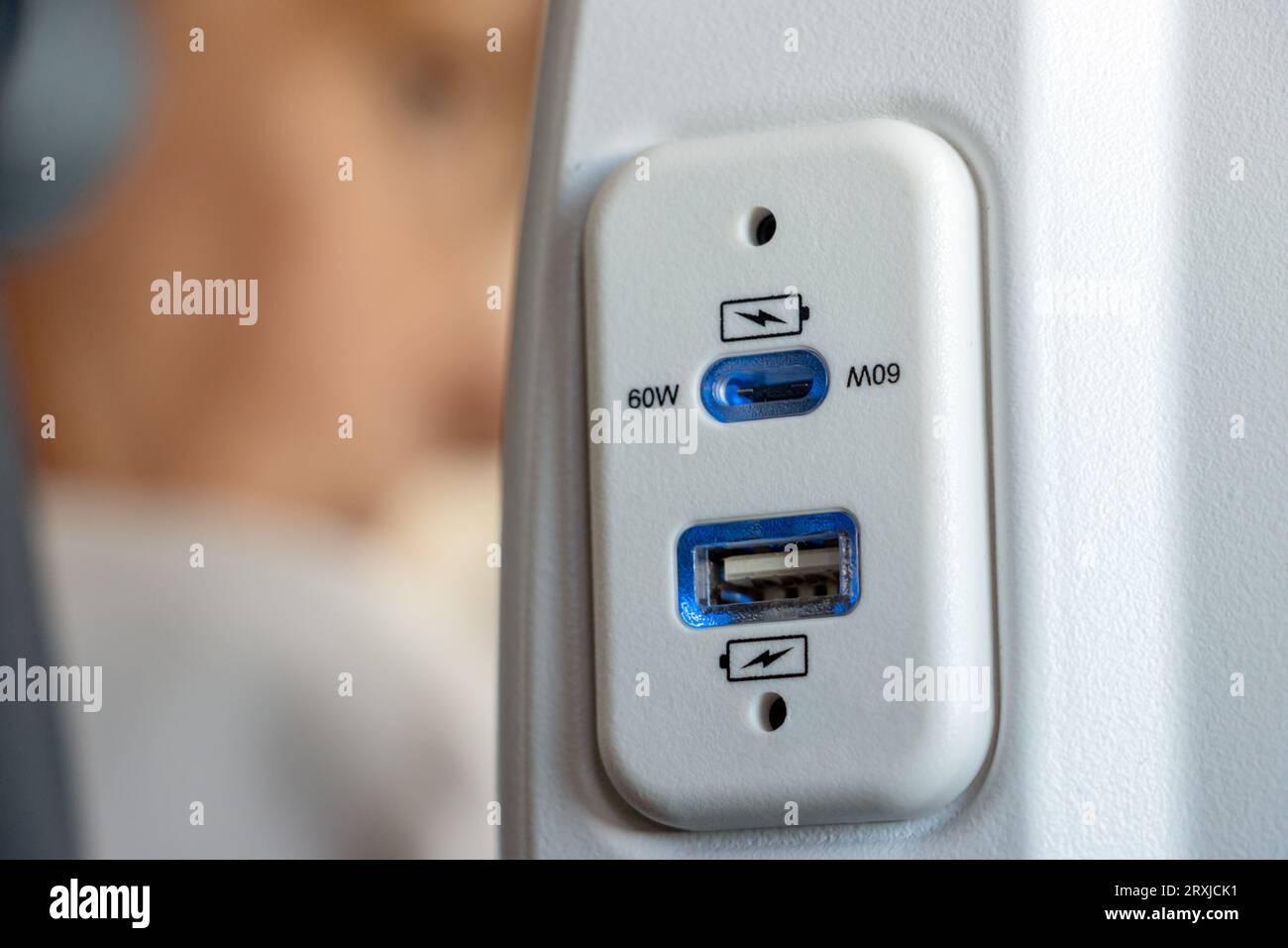 USB port at the seat of airplane for charging the electronics devices while traveling Stock Photo
