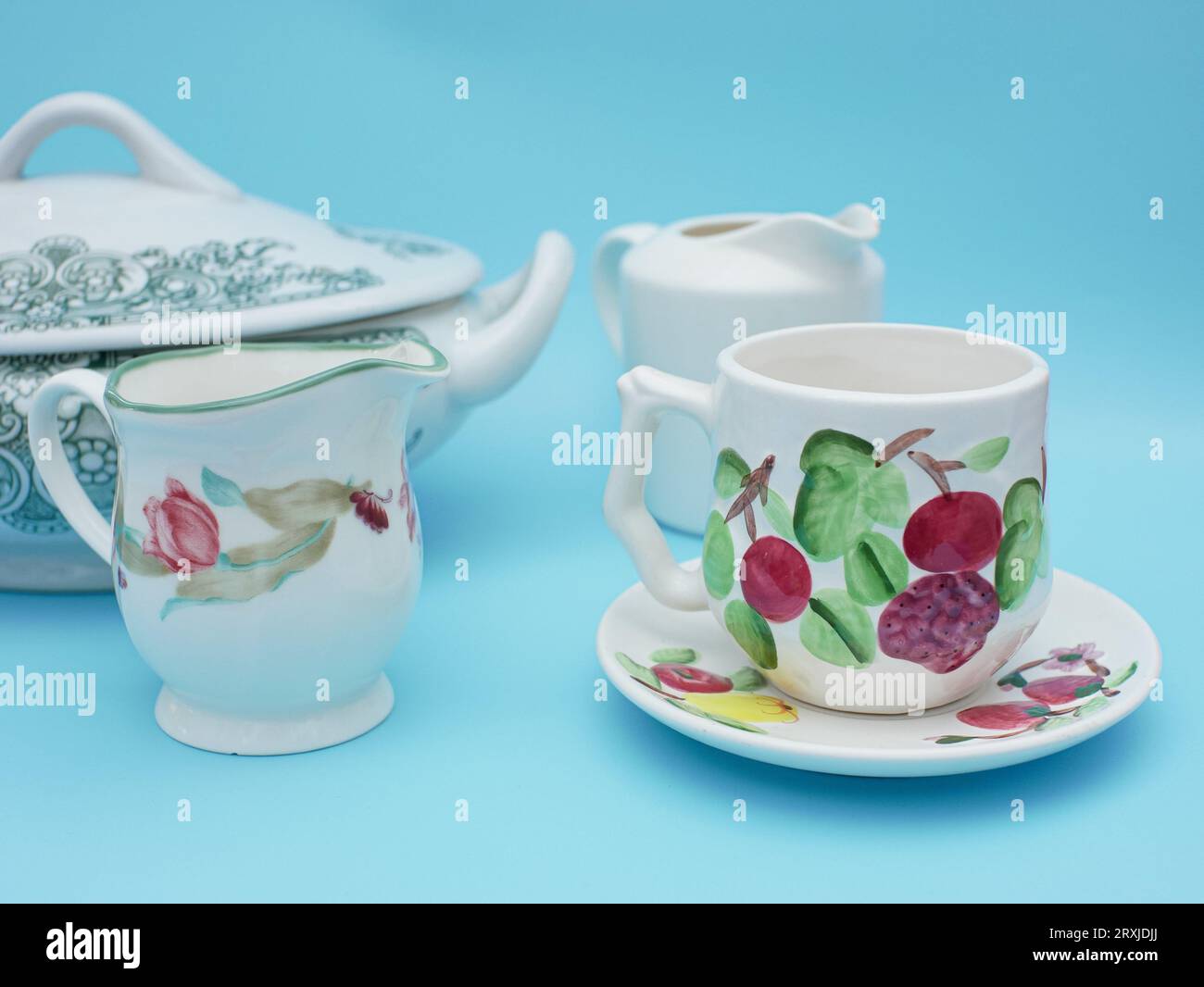 vintage set of cups isolated on blue background. Antique set tea cup with flower pattern asian style Stock Photo
