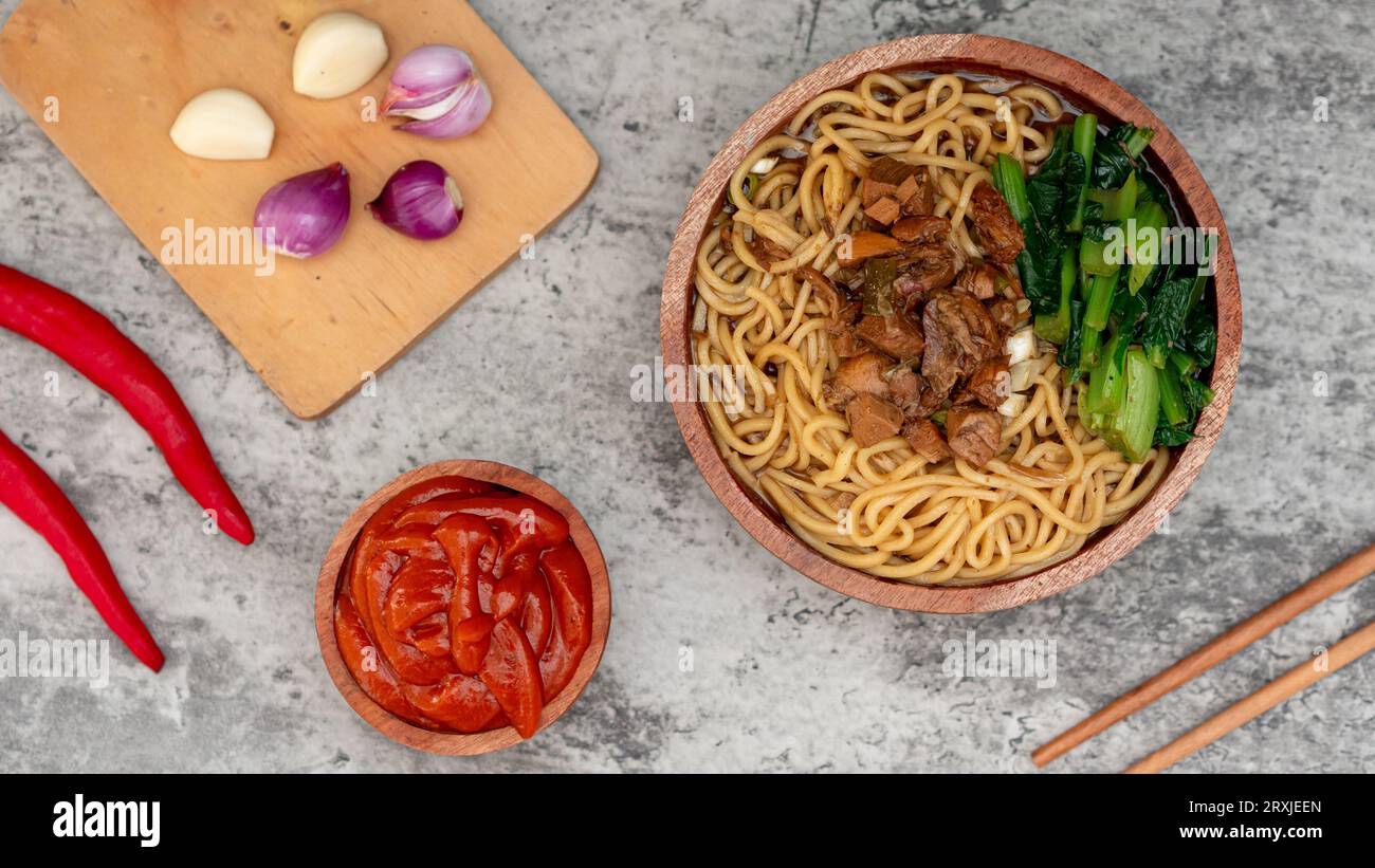 Indonesian chicken noodles called mie ayam topped with chicken meat and