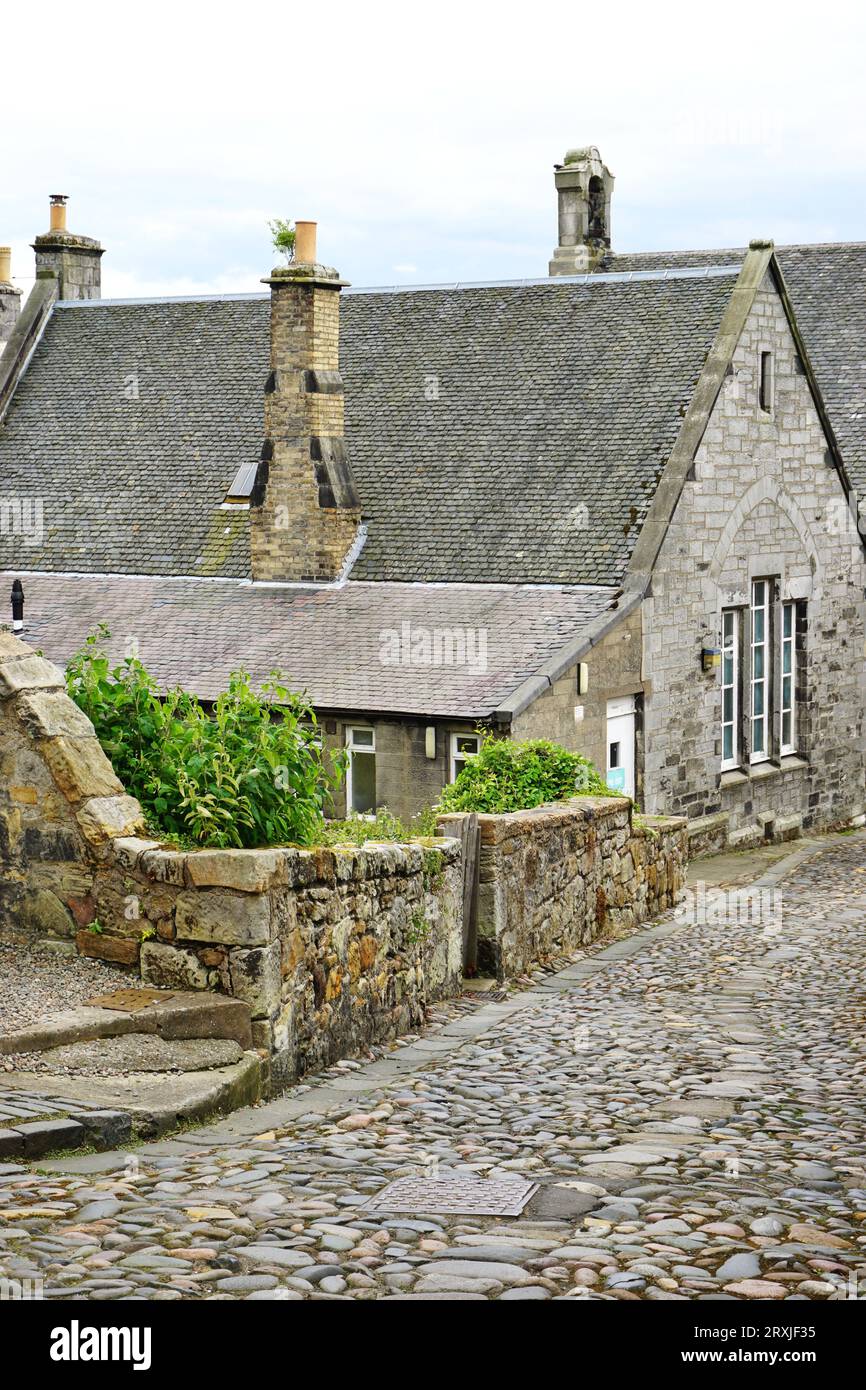 Historic stone house on a rough cobblestone roadway in the Village of Culross, Fife, Scotland. Many of the restored homes are leased out as residences Stock Photo